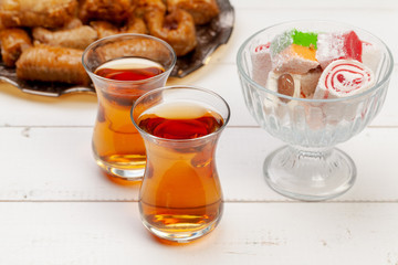 Cup of hot tea and a plate of turkish desserts