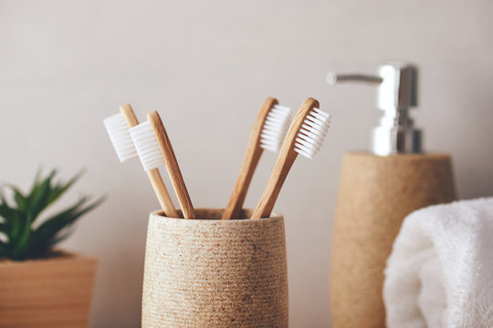 Close up of four bamboo toothbrushes in a cup