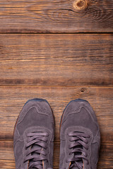 Fashionable men's sneakers top view. Men sneakers on a wooden background.