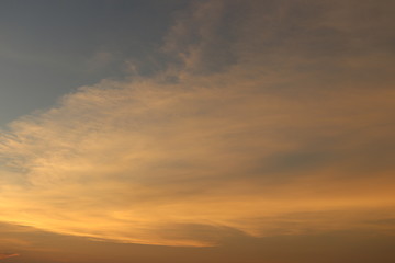 Fototapeta na wymiar Evening sky background, orange sun light on soft cloud.