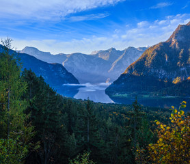 Peaceful morning autumn Alps mountain lake with clear transparent water and reflections. Hallstatter lake, Upper Austria.