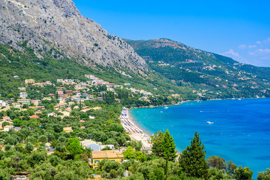 Barbati Beach with crystal clear azure water in beautiful landscape scenery - paradise coastline of Corfu island, Ionian archipelago, Greece.