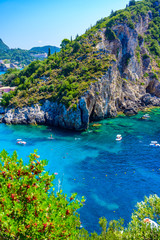 Agios Spiridon Beach with crystal clear azure water and white beach in beautiful landscape scenery - paradise coastline of Corfu island at Paleokastritsa, Ionian archipelago, Greece. - obrazy, fototapety, plakaty