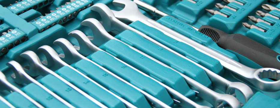 a fully stocked ratchet box with various bits and nuts