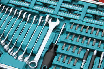 a fully stocked ratchet box with various bits and nuts