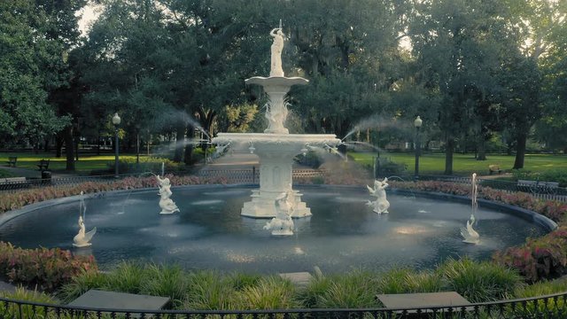 Aerial:  Fountain & oak trees with rays of light shining through. Forsyth Park. Savannah, Georgia, USA.