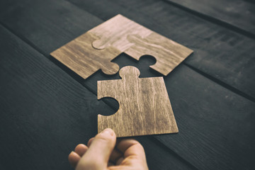 The woman hand connecting puzzles to each other