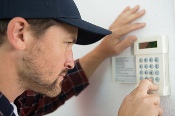 a male technician repairing intercom