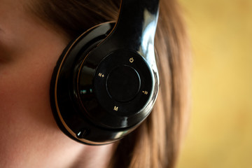 Woman putting earphones in the ear.