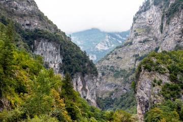Fototapeta na wymiar Rocky mountains above the road in Abkhazia