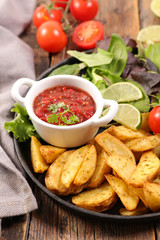 fried potato, tomato sauce and vegetable salad