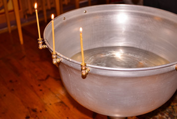  Font for the baptism of babies in the temple with candles.