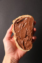 bread with chocolate spread in hand