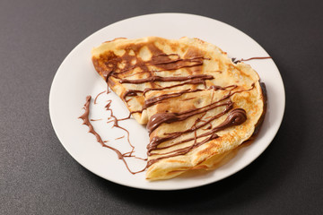 crepe with chocolate sauce in plate