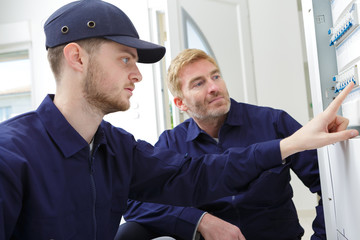 Obraz premium electricians installing energy saving meter