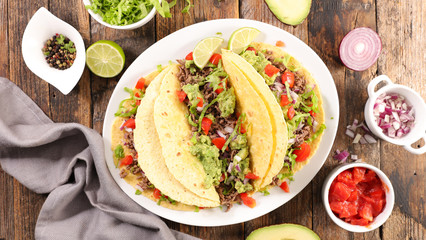 tacos with guacamole, beef, tomato and cheese- tortilla bread