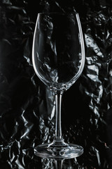 Glass wine glass stands on glass on black background