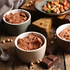 delicious vegan creamy chocolate mousse on wood background