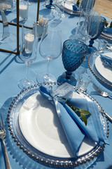 cutlery on a blue tablecloth in a restaurant
