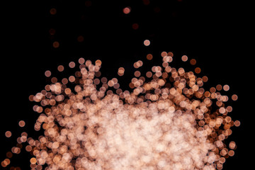 Golden shiny background of sparkles bokeh on black. New year concept.