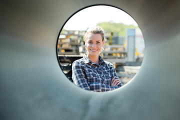 female worker looking through ventilation pipe
