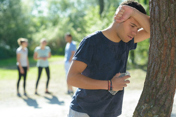 young man feeling sick doing outdoor exercise