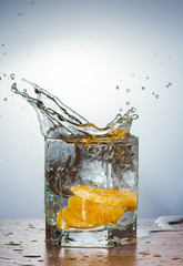 water splashes from mandarin slices on a light background