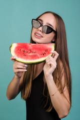 woman in a swimsuit with fruit in a photo studio