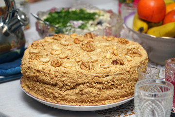Homemade delicious honey cake with nuts on a plate. Selective focus
