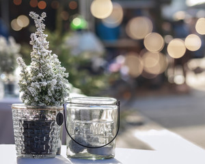 Little Christmas tree and a glass jar on a table 