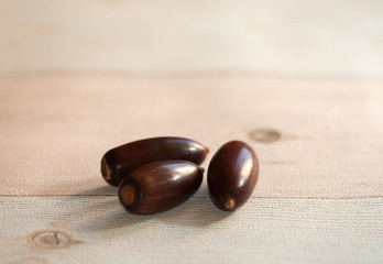 View on a group of brown corns in the light of autumn and lying on a wooden table.