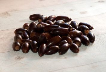 View on a group of brown corns in the light of autumn and lying on a wooden table.