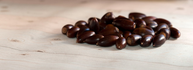View on a group of brown corns in the light of autumn and lying on a wooden table.