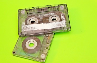 Old audio cassettes located on a green background