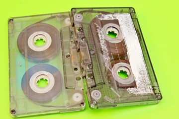 Old audio cassettes located on a green background