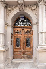wooden door with beautiful decorative metal bars in the historical part of Vienna