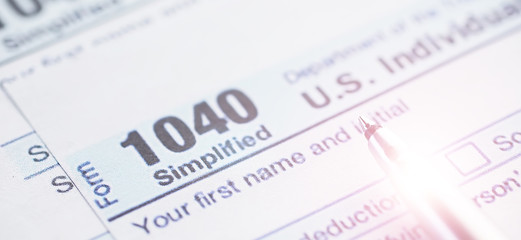 Annual tax reporting. Tax form on the table. Financial statements for signature.