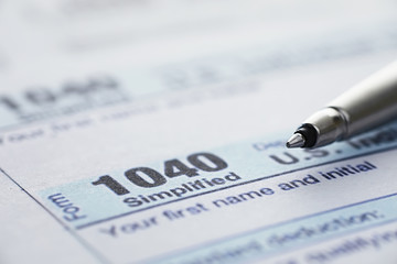 Annual tax reporting. Tax form on the table. Financial statements for signature.