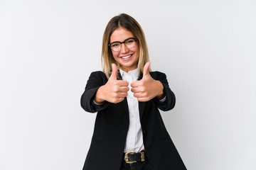 Young business caucasian woman with thumbs ups, cheers about something, support and respect concept.