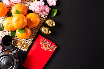 Chinese new year festival decorations pow or red packet, orange and gold ingots or golden lump on a...