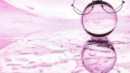 Tools for vision correction. Glasses and lenses with diopters on the background of splashes and blurry.