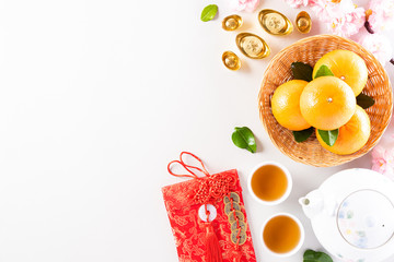 Chinese new year festival decorations pow or red packet, orange and gold ingots or golden lump on a...