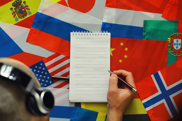 Learning foreign languages. Audio language courses. Background from countries flags and headphones...