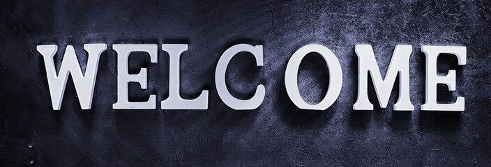 Background concept. Inscription Welcome on a dark background.