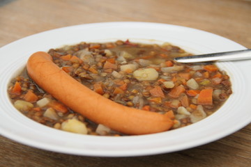 delicious freshly made lentil soup with a sausage