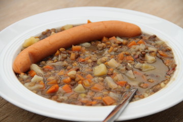delicious freshly made lentil soup with a sausage
