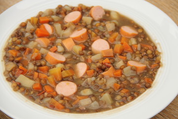 delicious freshly made lentil soup with a sausage