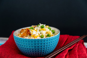 Homemade Chinese fried rice with vegetables and fried eggs