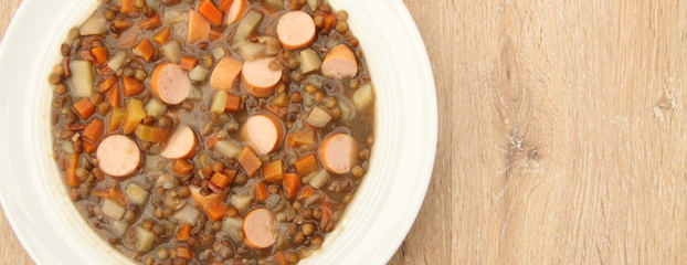 delicious freshly made lentil soup with a sausage