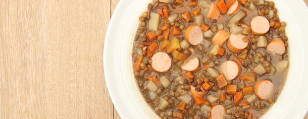 delicious freshly made lentil soup with a sausage